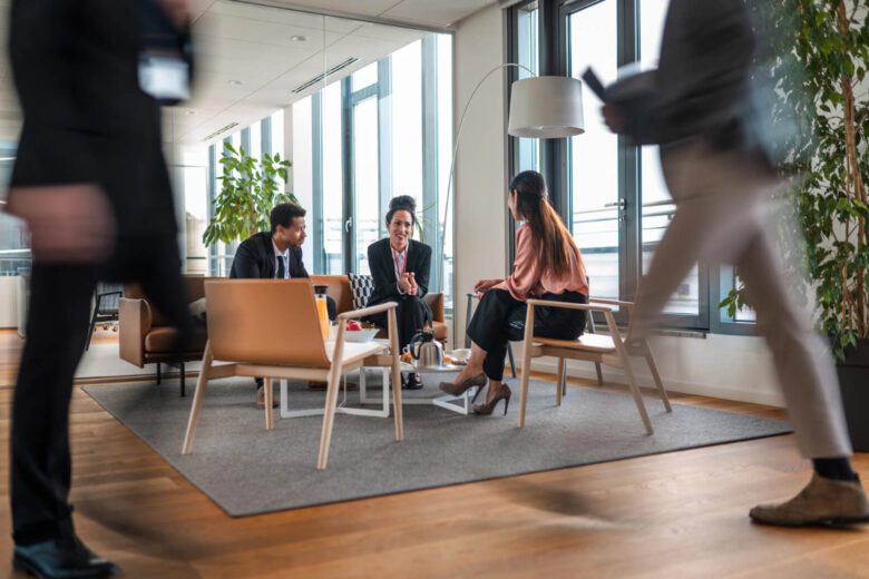 People in an office discussing around a coffee table